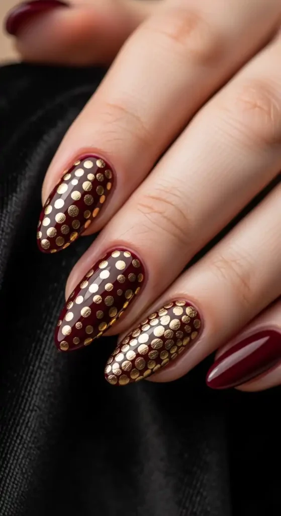 burgundy-nails-with-gold-foil-polka-dots